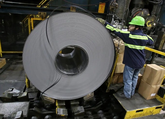 An image showing a worker handling steel | Source: Qz